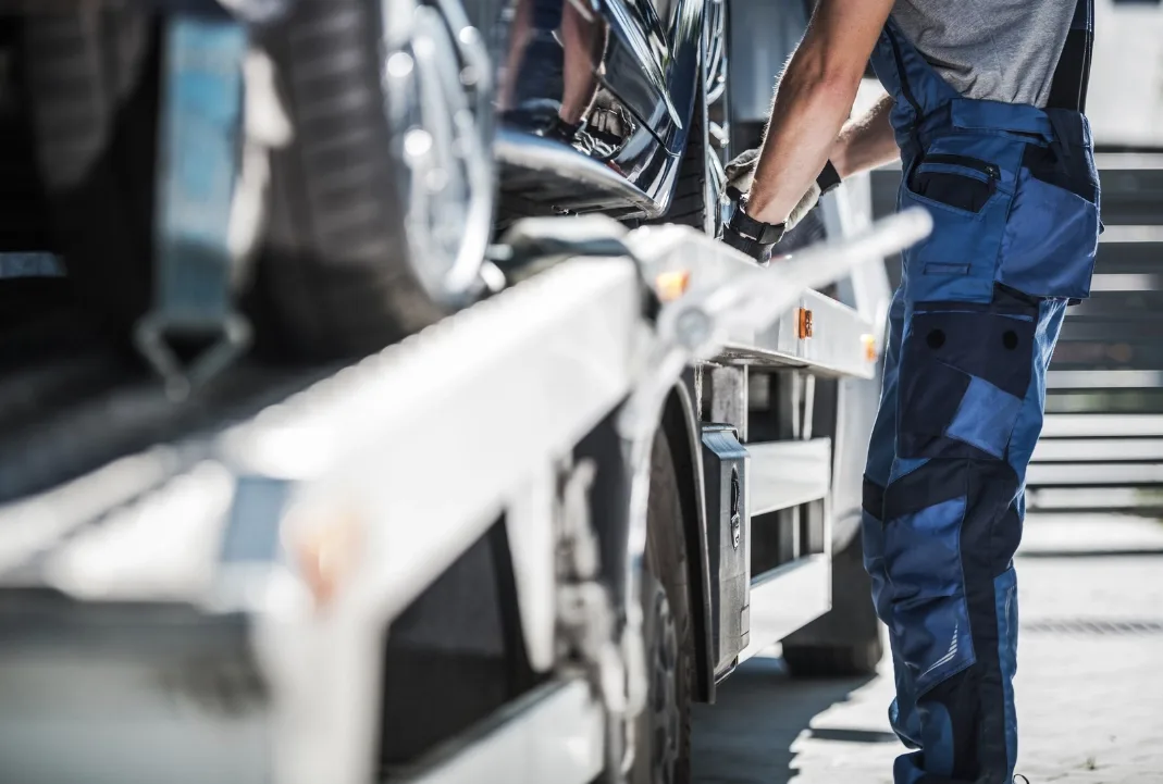 Chicago tow truck driver loading a car onto a flatbed